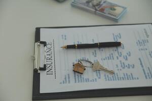 Real estate agent home sales broker is using a pen pointing to the house model and explains the business contract, rent, buy, mortgage, loan, or home insurance photo