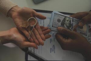 Real estate agent home sales broker is using a pen pointing to the house model and explains the business contract, rent, buy, mortgage, loan, or home insurance photo