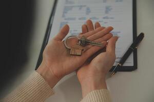 Real estate agent home sales broker is using a pen pointing to the house model and explains the business contract, rent, buy, mortgage, loan, or home insurance photo