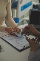 Real estate agent home sales broker is using a pen pointing to the house model and explains the business contract, rent, buy, mortgage, loan, or home insurance photo