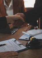 concept of justice and law A male judge in the courtroom on a wooden table and a male counselor or lawyer working in the office. Law, advice and justice concepts. photo