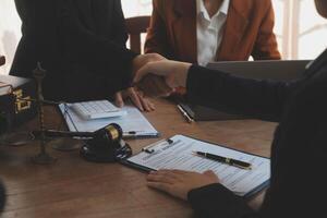 concept of justice and law A male judge in the courtroom on a wooden table and a male counselor or lawyer working in the office. Law, advice and justice concepts. photo