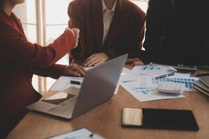 Close up of a team of business people having a meeting to analyze data for a marketing plan. photo
