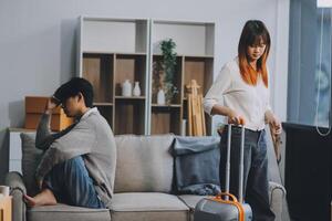 Offended couple ignoring each other after quarrel indoors, selective focus. Relationship problems photo