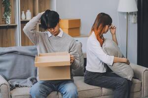 Offended couple ignoring each other after quarrel indoors, selective focus. Relationship problems photo
