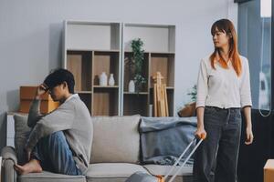 Offended couple ignoring each other after quarrel indoors, selective focus. Relationship problems photo