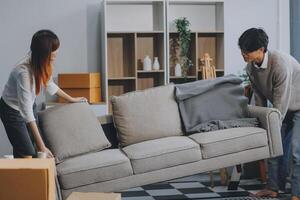 Asian Female discussing new project with male colleague. Young woman talking with young Asian man with financial on sofa in home office photo
