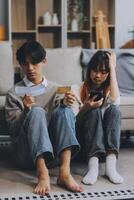 Worried annoyed young husband wife using phone credit card dissatisfied with interrupted wifi internet connection slow bad app work. Angry family couple bank clients unable to pay online check balance photo
