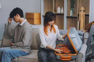 Offended couple ignoring each other after quarrel indoors, selective focus. Relationship problems photo