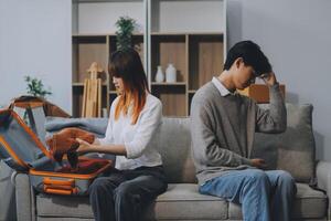 Offended couple ignoring each other after quarrel indoors, selective focus. Relationship problems photo