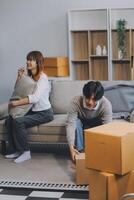Offended couple ignoring each other after quarrel indoors, selective focus. Relationship problems photo