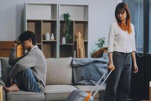 Offended couple ignoring each other after quarrel indoors, selective focus. Relationship problems photo