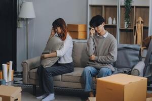 Offended couple ignoring each other after quarrel indoors, selective focus. Relationship problems photo