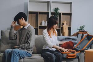Offended couple ignoring each other after quarrel indoors, selective focus. Relationship problems photo
