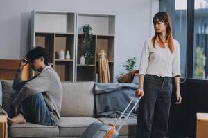 Offended couple ignoring each other after quarrel indoors, selective focus. Relationship problems photo
