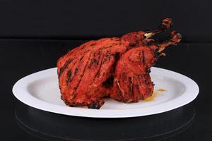 A plate with a large grilled chicken photo