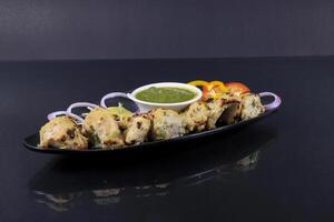 A plate with chicken skewers and sauce photo