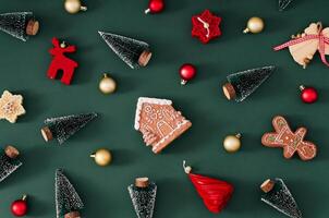 Trendy Christmas pattern made of various winter and Xmas objects on green background. Minimal creative Christmas and New Year concept. Festive holiday pattern backdrop. Christmas aesthetic. Flat lay. photo