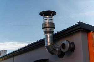 Ventilation system attached to the roof of a modern building photo