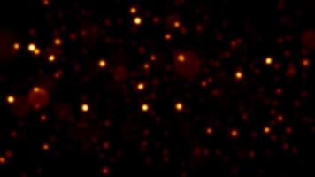 Loop blurred gold red bokeh particles animation on black background video