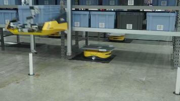 Demonstration of Smart warehouse management system with robotic handling system. Automated robotic tote arranging distribution product stock on shelf in modern factory. AI Technology Logistic concept. video