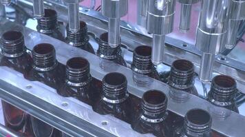 Bottles filling automation machine in modern factory. Technology demonstration of filling and capping bottles in the industry. Inspection of Vials For Defects. Pharmaceutical and drink Manufacturing. video