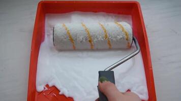 Womens hands using paint roller while working indoors video