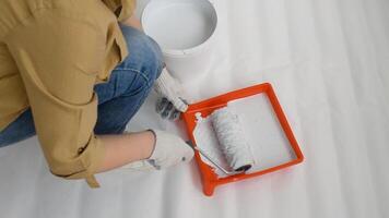 Womens hands using paint roller while working indoors video