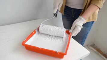 Womens hands using paint roller while working indoors video