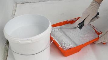 Womens hands using paint roller while working indoors video