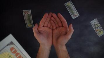 Banknotes fall from above and open palms video