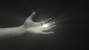 A hand reaching towards a beacon of light amidst darkness video