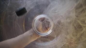 Vitamins fall from inside container with smoke into the palm of the love video