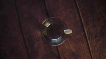 Hand drops a pill into water video