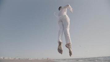 An Ethereal Jump at the Beach while Dressed in White Attire video