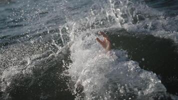 Person's hand comes out of the water video