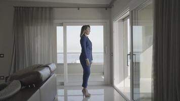 Serious woman with heels looks in the window at home video