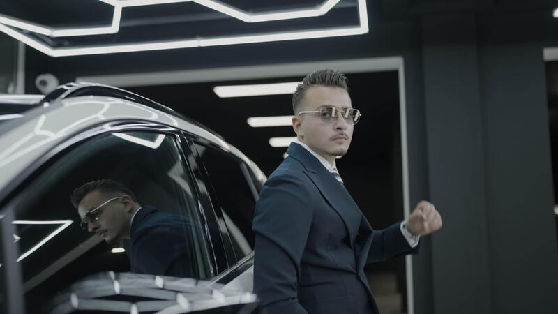 A Stylish Businessman Posing Confidently in a Luxury Car Environment A Stylish Businessman Posing Confidently in a Luxury Car Environment
