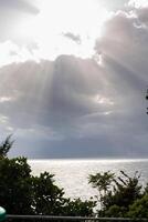 sun rays from behind clouds photo