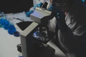 professional chemist woman laboratory using scientific microscope for science research, chemistry scientist with microbiology medicals equipment technology to working with medicine biology experiment photo