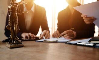 Lawyer, legal advisor, businessman brainstorming information on agreement details Business contracts in legal processing books for accuracy in contract documents. joint financial investment. photo