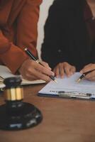 Lawyer, legal advisor, businessman brainstorming information on agreement details Business contracts in legal processing books for accuracy in contract documents. joint financial investment. photo