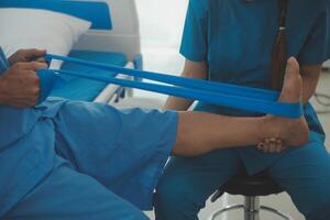 Physical therapists work with patients in close-up clinics. The concept of rehabilitation of physical health, the doctor gives advice to the patient. Ankle problems and muscle injuries photo