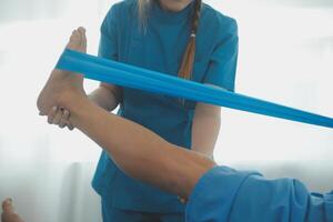 Physical therapists work with patients in close-up clinics. The concept of rehabilitation of physical health, the doctor gives advice to the patient. Ankle problems and muscle injuries photo