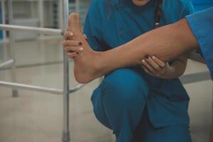 Physical therapists work with patients in close-up clinics. The concept of rehabilitation of physical health, the doctor gives advice to the patient. Ankle problems and muscle injuries photo