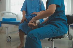 Physical therapists work with patients in close-up clinics. The concept of rehabilitation of physical health, the doctor gives advice to the patient. Ankle problems and muscle injuries photo