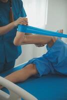 Physical therapists work with patients in close-up clinics. The concept of rehabilitation of physical health, the doctor gives advice to the patient. Ankle problems and muscle injuries photo