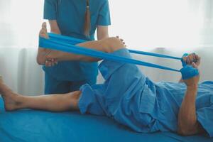 Physical therapists work with patients in close-up clinics. The concept of rehabilitation of physical health, the doctor gives advice to the patient. Ankle problems and muscle injuries photo
