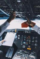 Professional pilot woman in uniform has teamwork meeting for success flight in aviation business. Young female captain instructor sitting in office and working or training commercial airline crew. photo