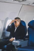 headache in the airplane, man passenger afraid and feeling bad during the flight in plane photo